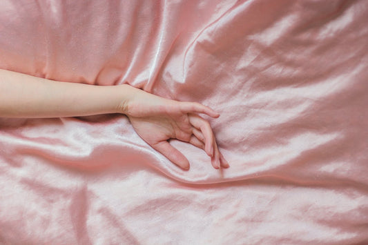 Hand laid across silk bedding