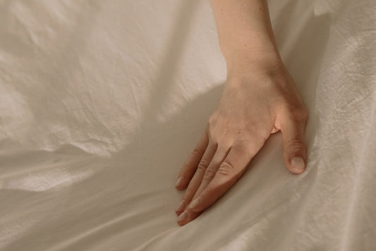flat hand on a bed sheet