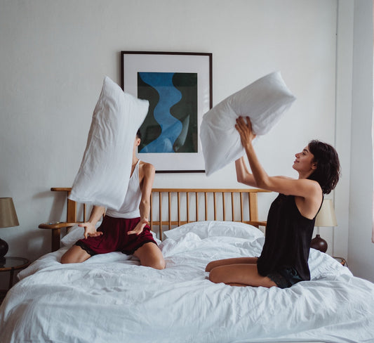 Two Women Playing With Pillows