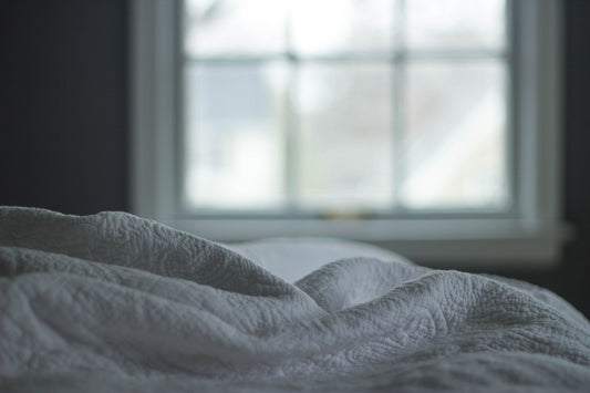 close up of blanket on bed in bedroom