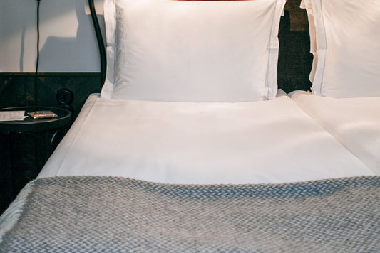 white bedspread with white pillows