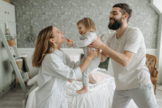 parents Playing with Their Daughter in Bedroom