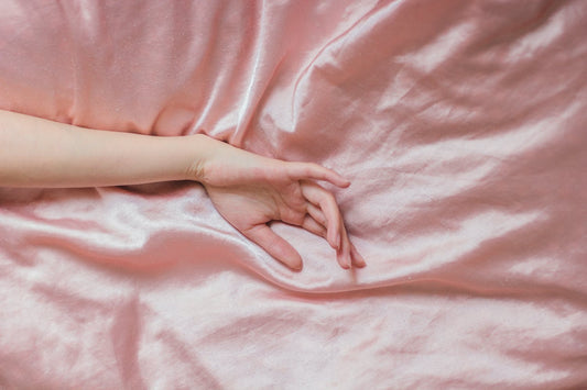Hand laid across silk bedding