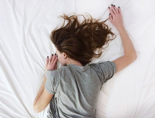 woman lying on a bedsheet